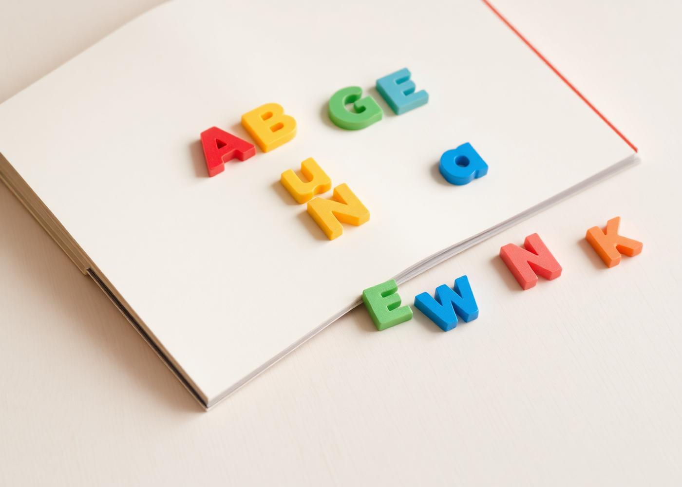 Colorful letter tiles on an open book